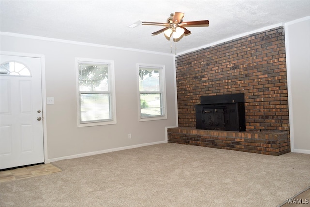 unfurnished living room featuring light carpet, a fireplace, ceiling fan, and crown molding