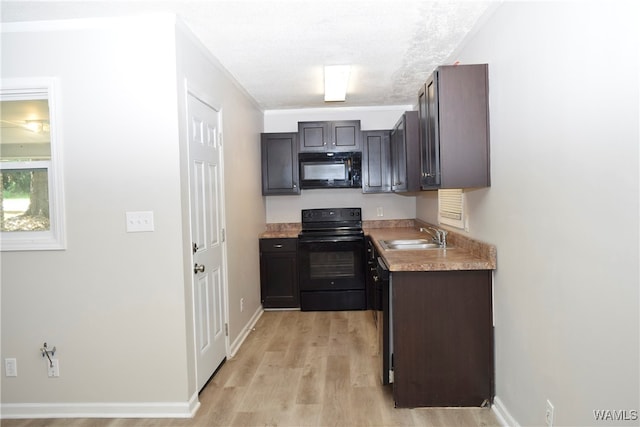 kitchen featuring dark brown cabinets, sink, light hardwood / wood-style floors, and black appliances