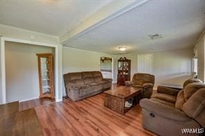 living room with hardwood / wood-style floors and beamed ceiling