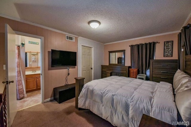 bedroom with ornamental molding, sink, light colored carpet, and a textured ceiling