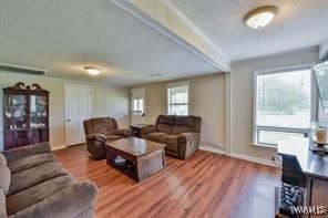 living room with hardwood / wood-style floors and a textured ceiling