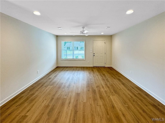 unfurnished living room with baseboards, recessed lighting, ceiling fan, and wood finished floors