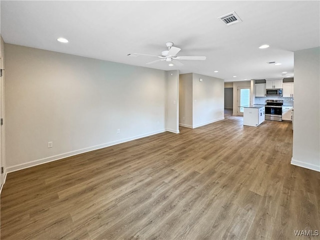 unfurnished living room with baseboards, ceiling fan, recessed lighting, and visible vents