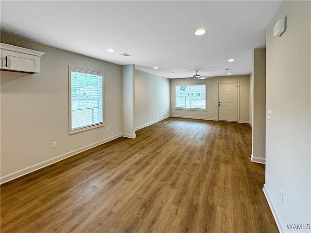 unfurnished room featuring ceiling fan, recessed lighting, baseboards, wood finished floors, and visible vents