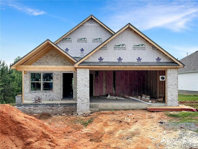 property under construction with a patio area and brick siding