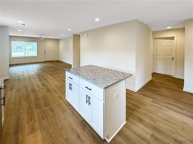 11604 Cripple Creek Rd, Berry, AL 35546 - kitchen with a ceiling fan, a center island, light stone countertops, white cabinetry, and wood finished floors