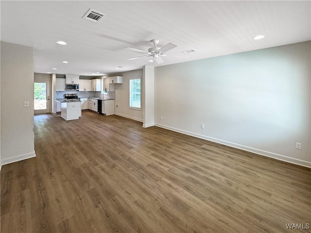 11604 Cripple Creek Rd, Berry, AL 35546 - unfurnished living room featuring baseboards, dark wood-style flooring, plenty of natural light, and recessed lighting