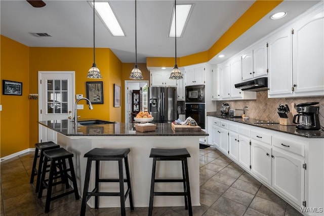 1137 Germantown Rd, Tuscaloosa, AL 35406 - kitchen featuring black appliances, under cabinet range hood, white cabinetry, tasteful backsplash, and recessed lighting