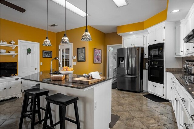 1137 Germantown Rd, Tuscaloosa, AL 35406 - kitchen featuring black appliances, white cabinets, pendant lighting, and a breakfast bar area