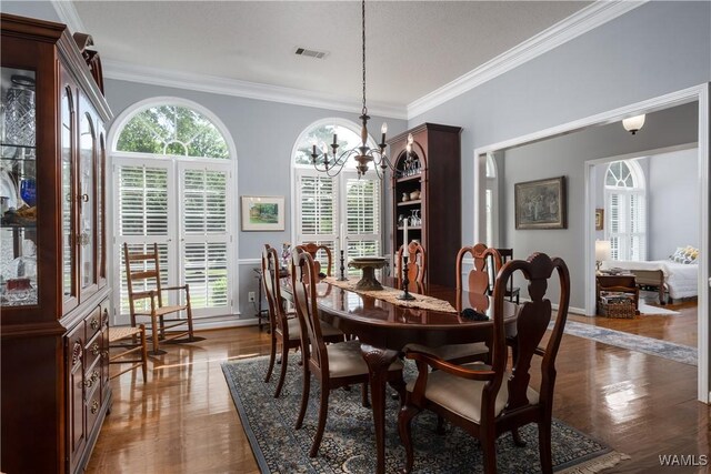 1137 Germantown Rd, Tuscaloosa, AL 35406 - dining area with ornamental molding, healthy amount of natural light, a chandelier, and dark wood finished floors