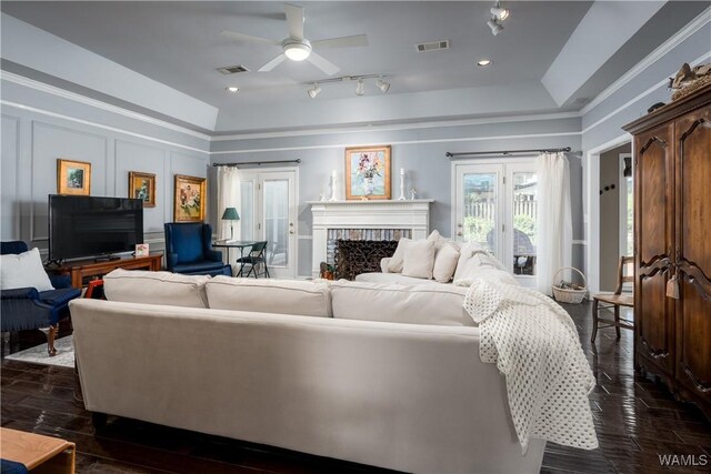 1137 Germantown Rd, Tuscaloosa, AL 35406 - living area with dark wood finished floors, a ceiling fan, a fireplace, a decorative wall, and track lighting