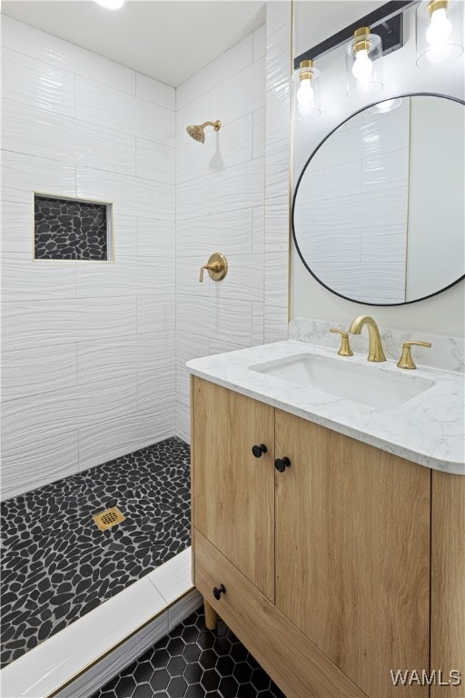 bathroom with vanity and tiled shower