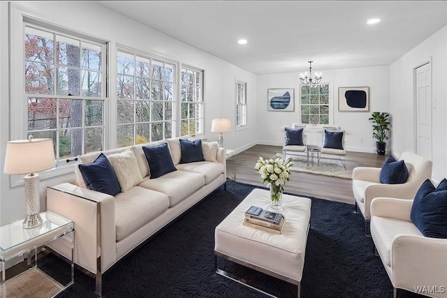 living room featuring a notable chandelier, recessed lighting, baseboards, and wood finished floors