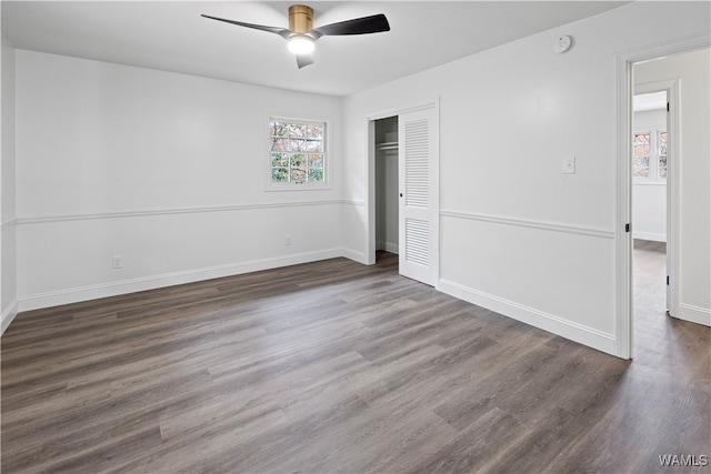 unfurnished bedroom with a closet, a ceiling fan, baseboards, and wood finished floors