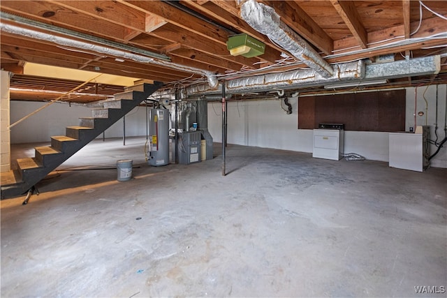 unfinished below grade area featuring stairs, washer / clothes dryer, and water heater