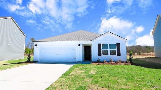 view of front of property featuring a garage and a front lawn