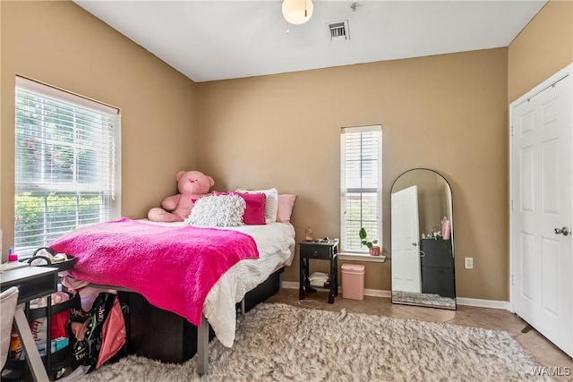 303 Helen Keller Blvd Unit B117, Tuscaloosa, AL 35404 - bedroom featuring tile patterned flooring, visible vents, multiple windows, and baseboards