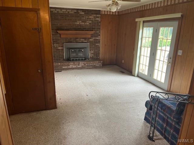 145 Lecroy Cir, Brent, AL 35034 - unfurnished living room featuring ceiling fan, carpet, wood walls, and crown molding