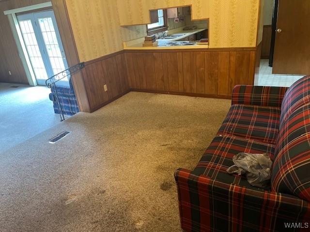 145 Lecroy Cir, Brent, AL 35034 - unfurnished room featuring wallpapered walls, a wainscoted wall, plenty of natural light, carpet floors, and wood walls