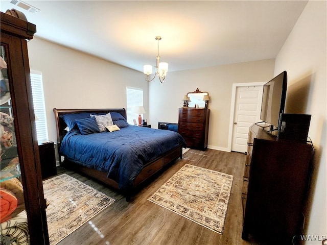 15525 Tide Water Ter, Brookwood, AL 35444 - bedroom with wood finished floors, a chandelier, and baseboards