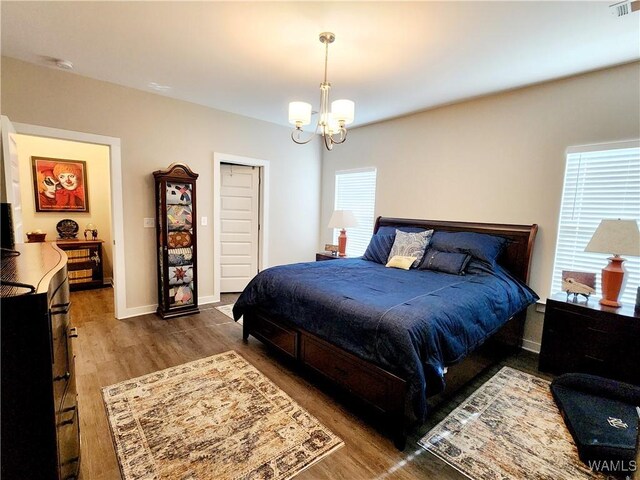 15525 Tide Water Ter, Brookwood, AL 35444 - bedroom with wood finished floors, a chandelier, and baseboards