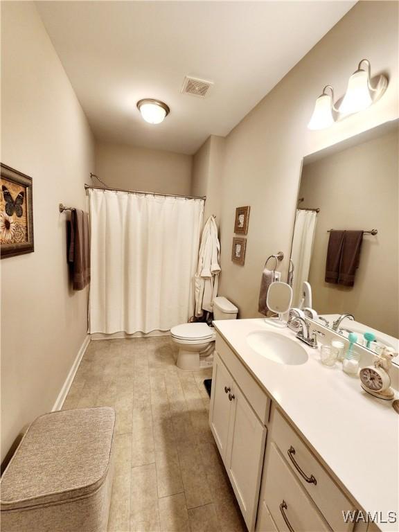 15525 Tide Water Ter, Brookwood, AL 35444 - bathroom with vanity, toilet, and a shower with shower curtain