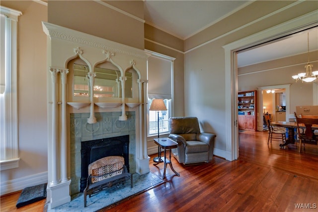 living room featuring a chandelier, hardwood / wood-style floors, and ornamental molding