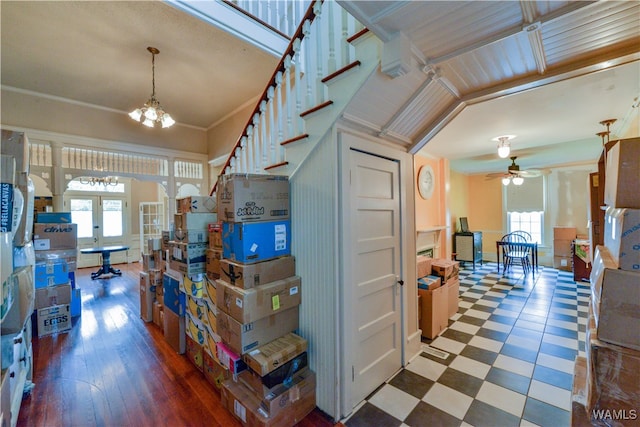 interior space featuring hardwood / wood-style floors, a healthy amount of sunlight, ornamental molding, and french doors