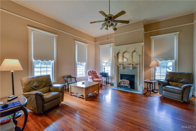 living room with dark hardwood / wood-style floors, plenty of natural light, crown molding, and ceiling fan