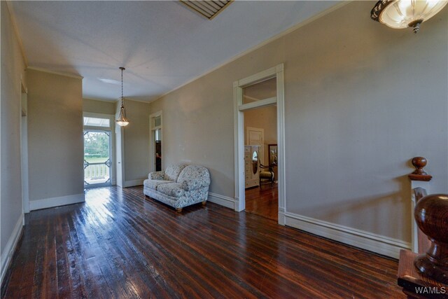 unfurnished room featuring dark hardwood / wood-style floors and ornamental molding