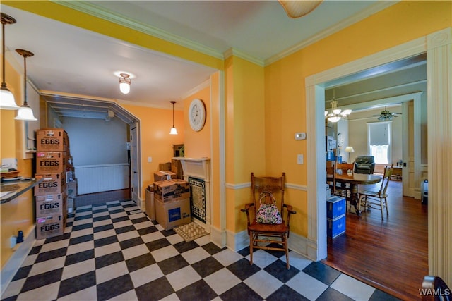 interior space featuring crown molding, dark wood-type flooring, and a notable chandelier