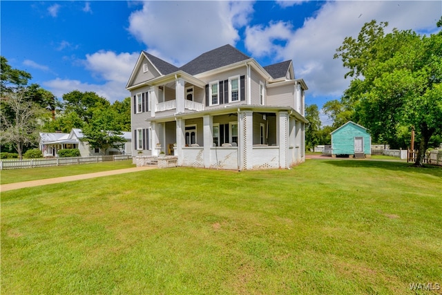 view of front of house with covered porch and a front lawn