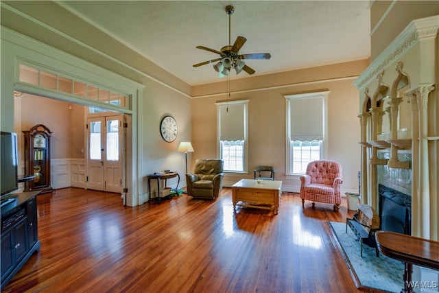 living room with a premium fireplace, french doors, ceiling fan, and dark hardwood / wood-style floors