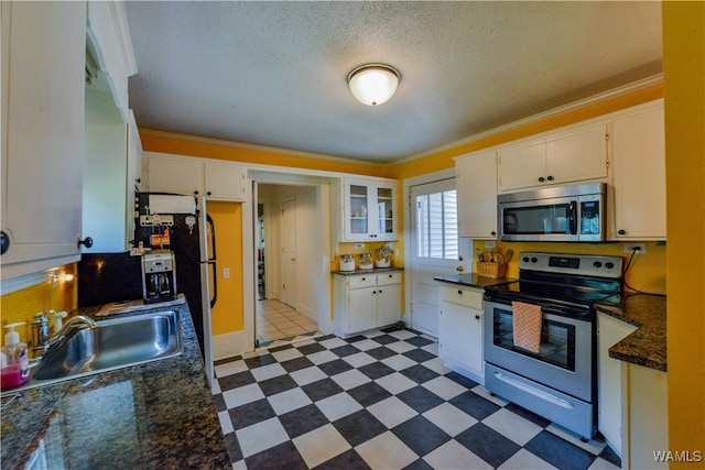 kitchen with appliances with stainless steel finishes, white cabinetry, crown molding, and sink