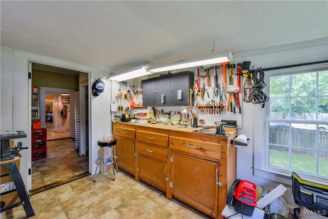 kitchen featuring a textured ceiling and tasteful backsplash