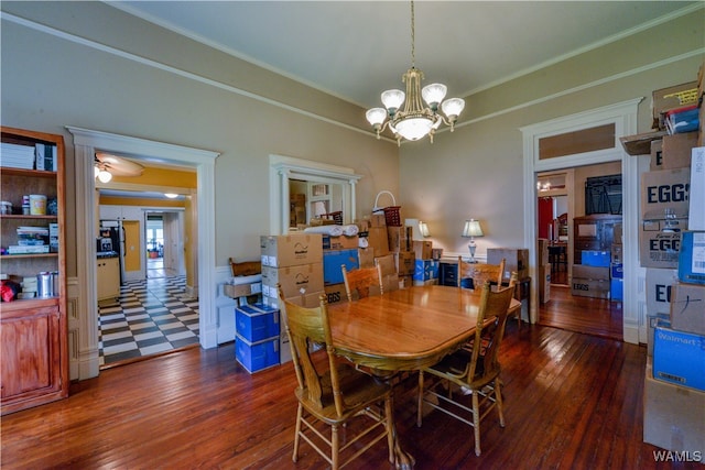 dining room with a chandelier, dark hardwood / wood-style flooring, and ornamental molding