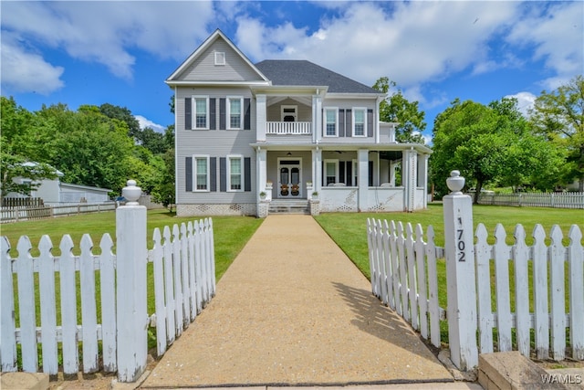 view of front of home with a balcony, a front lawn, and covered porch