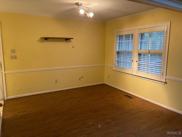 spare room with dark hardwood / wood-style floors and crown molding