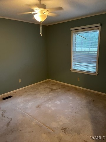 carpeted spare room with ceiling fan and ornamental molding