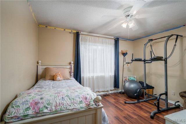 bedroom featuring ceiling fan, a textured ceiling, and hardwood / wood-style flooring