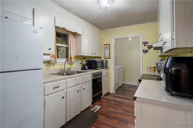 kitchen with washer and clothes dryer, sink, black dishwasher, white fridge, and white cabinetry