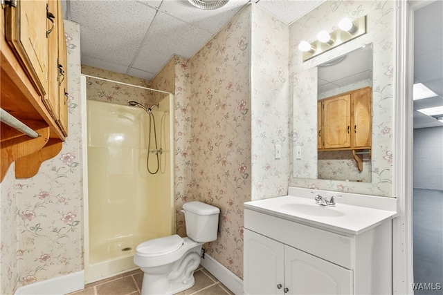 bathroom featuring a shower, vanity, tile patterned flooring, and toilet