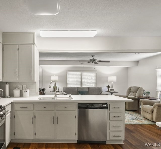 kitchen featuring backsplash, dark wood-type flooring, sink, ceiling fan, and appliances with stainless steel finishes