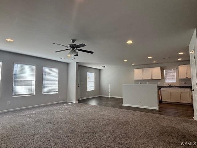 unfurnished living room with baseboards, dark carpet, recessed lighting, and ceiling fan