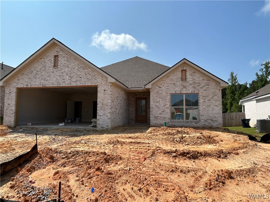 12692 Windword Pointe Dr, Northport, AL 35475 - view of front of home featuring brick siding, an attached garage, central air condition unit, and a shingled roof