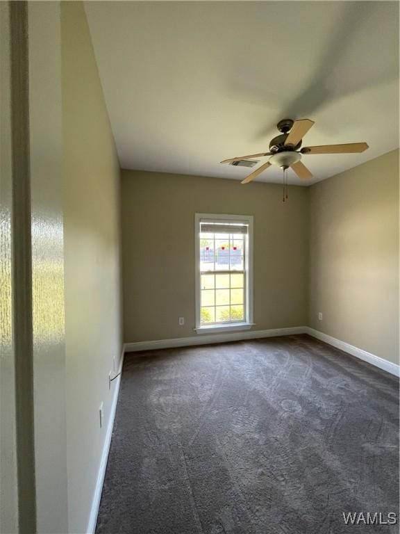 unfurnished room with baseboards, a ceiling fan, and carpet