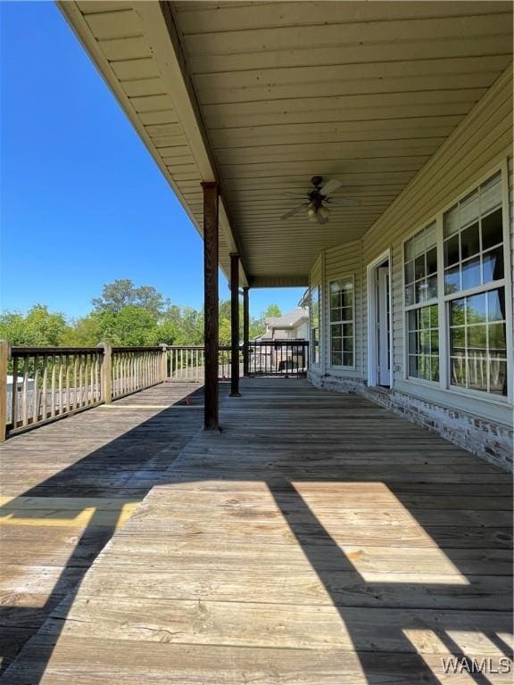 wooden deck featuring a ceiling fan