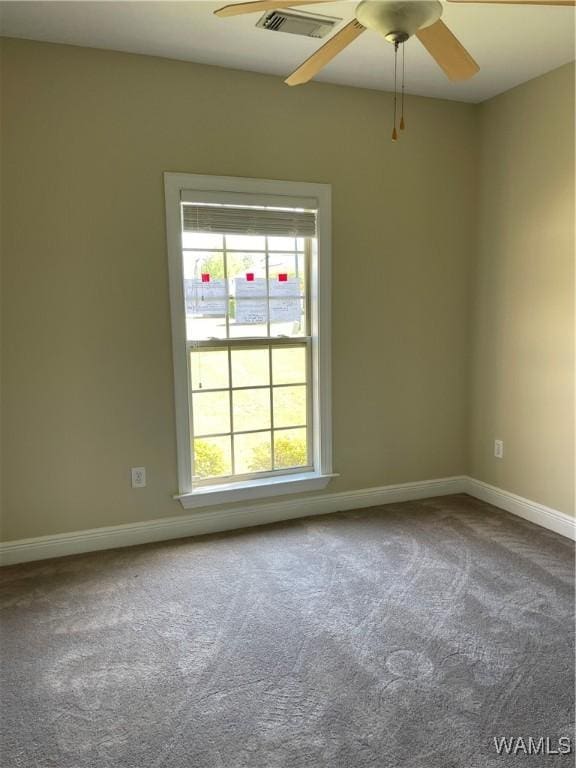 unfurnished room featuring visible vents, carpet flooring, baseboards, and ceiling fan