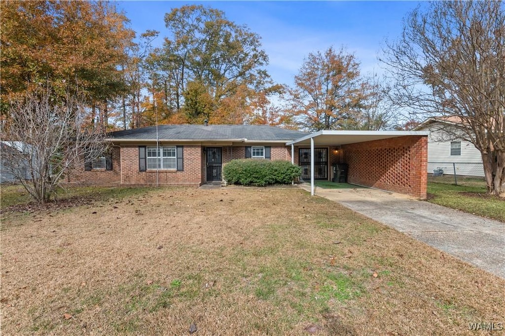 single story home featuring a front lawn and a carport