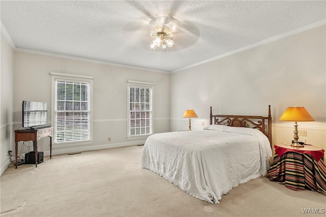 carpeted bedroom featuring crown molding, baseboards, ceiling fan, and a textured ceiling